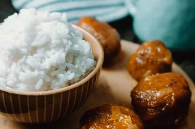 Bowl Of White Rice With Glazed Meatballs
