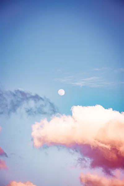 Full Moon Rising Above Colorful Sunset Clouds