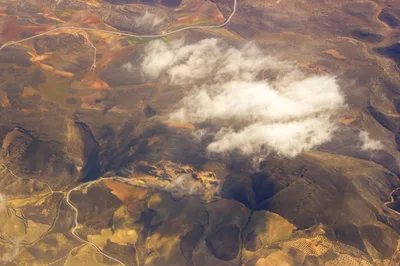 Aerial View Of Rugged Mountain Landscape With Clouds