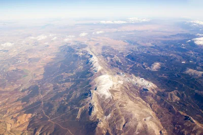 Aerial View Of Snow Capped Mountain Range