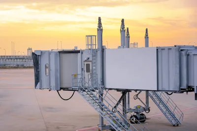 Airport Passenger Boarding Bridge at Sunset