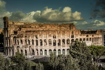 The Colosseum Amphitheatre Under A Dramatic Cloudy Sky