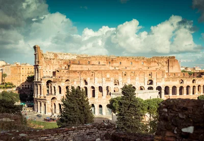 The Colosseum Amphitheater Under A Dramatic Cloudy Sky