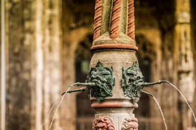 Ornate Stone Fountain Spouting Water In Historic Setting