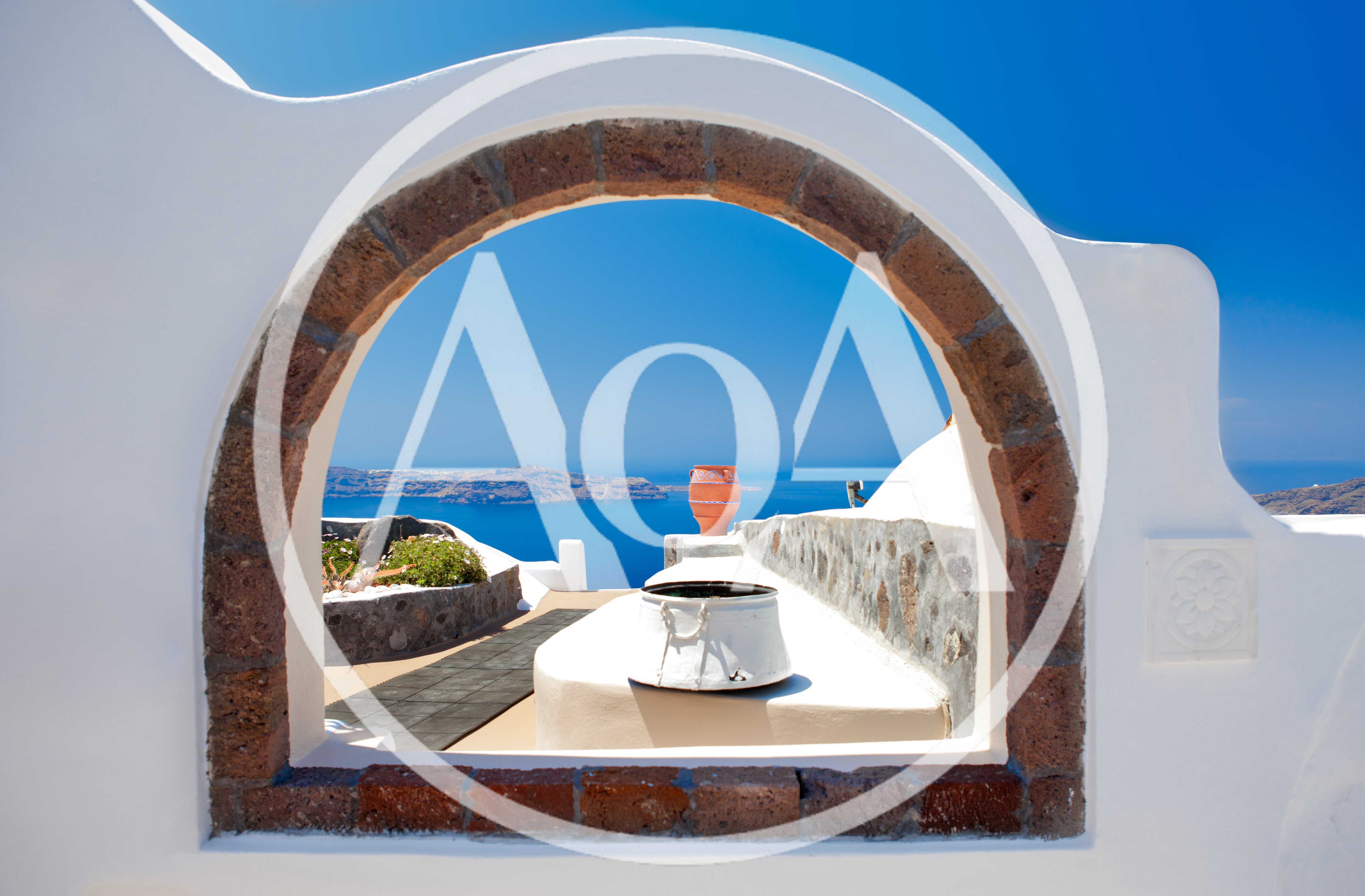 Framed View Of Santorini Caldera Through Stone Archway