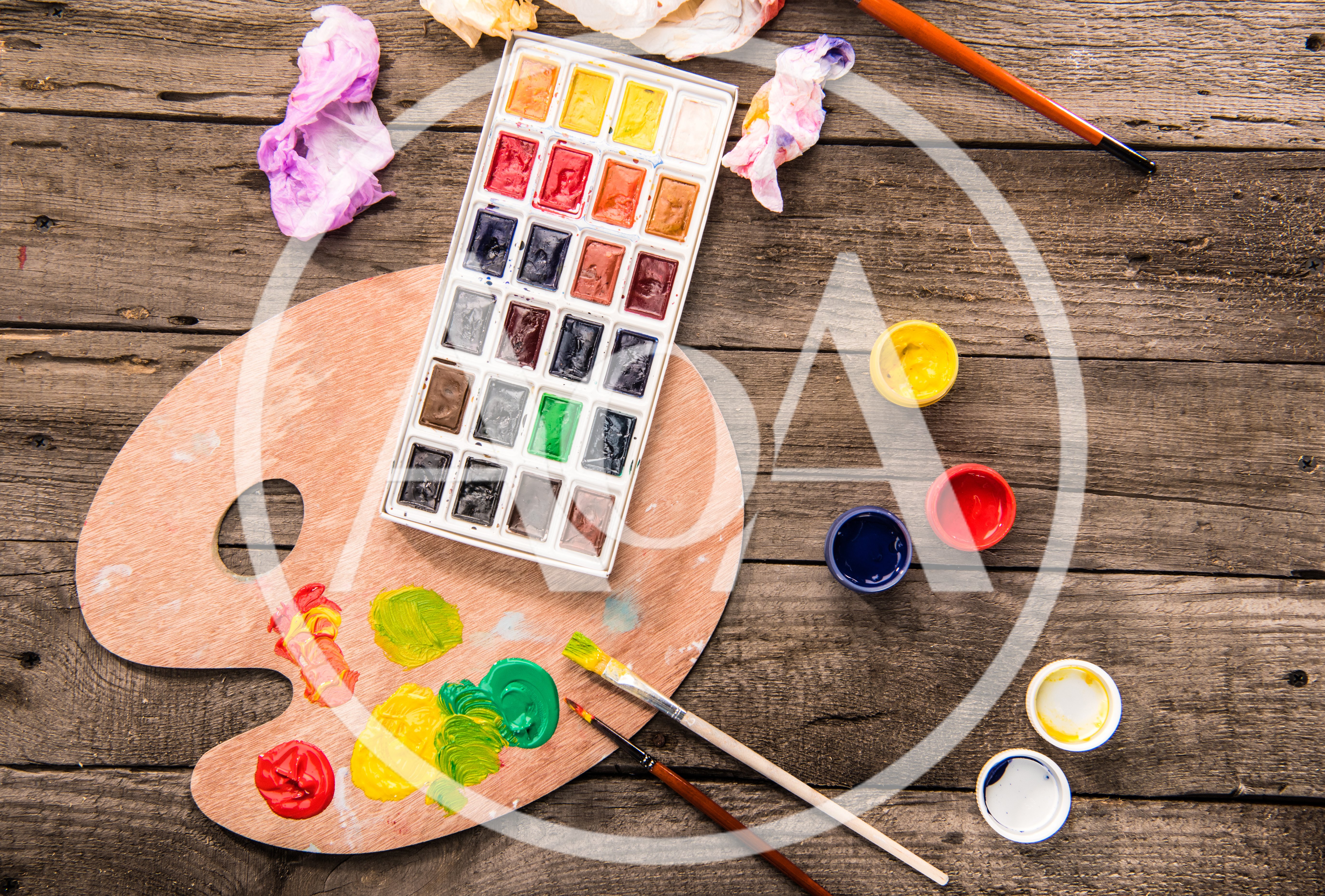 Watercolor Paint Set and Wooden Palette on Rustic Table