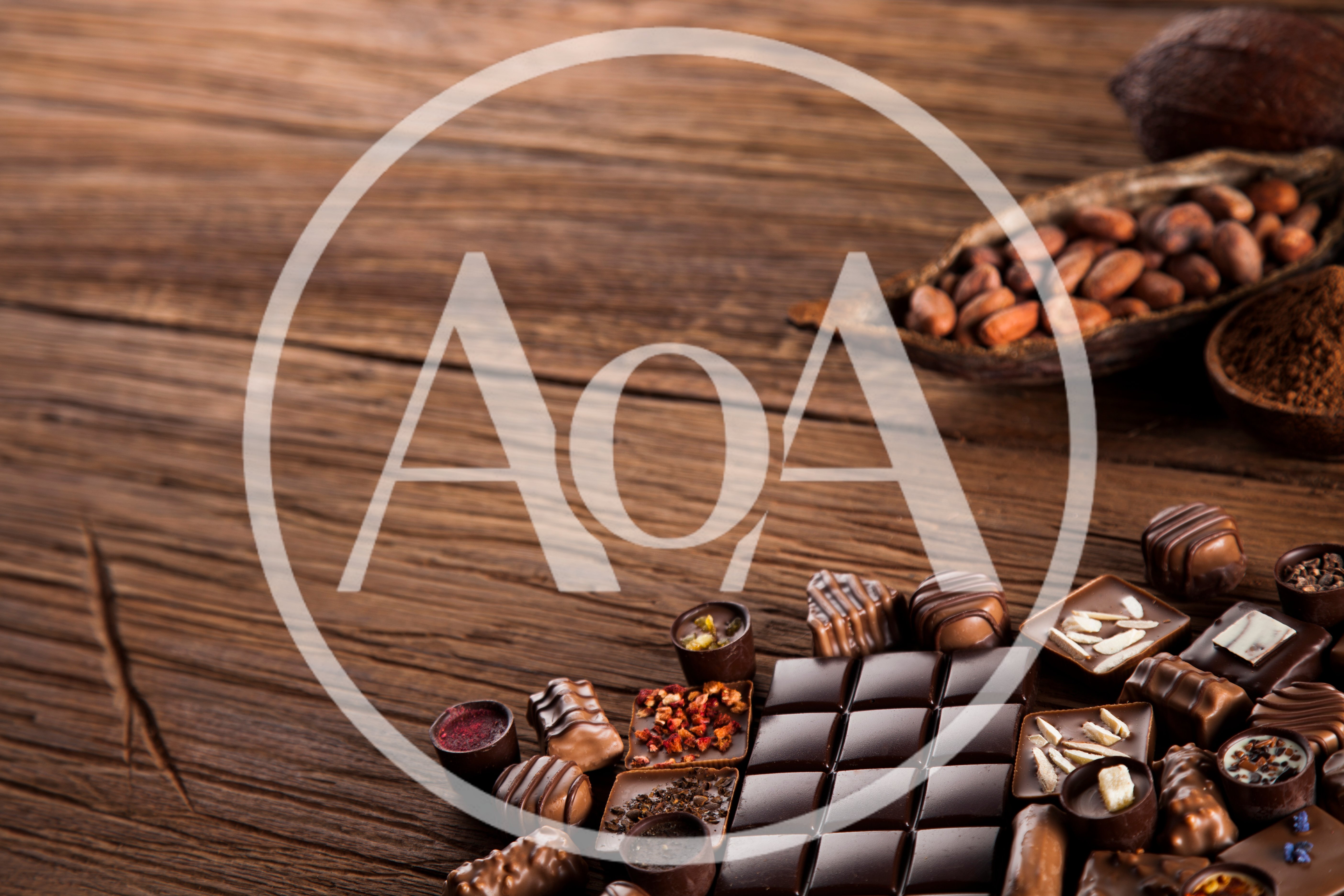 Assorted Gourmet Chocolates and Cocoa Beans on Wooden Table