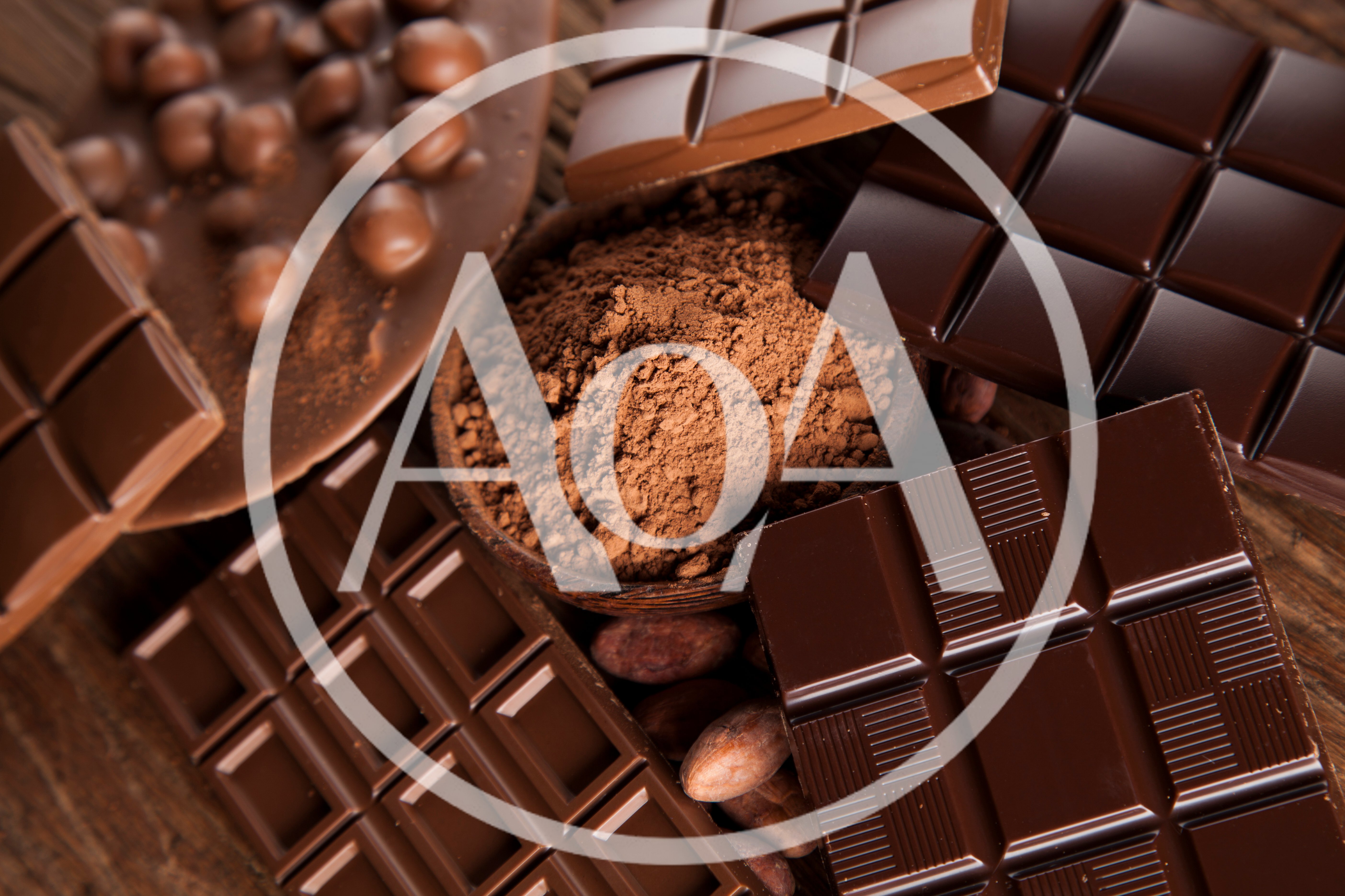 Assorted Chocolate Bars And Cocoa Powder On Wooden Table