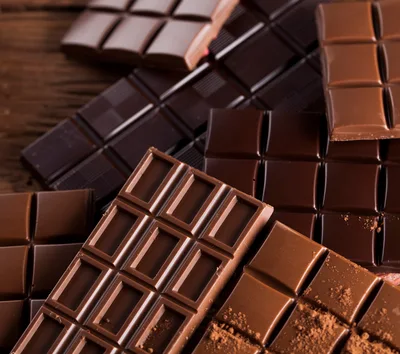 Assorted Chocolate Bars On A Rustic Wooden Surface