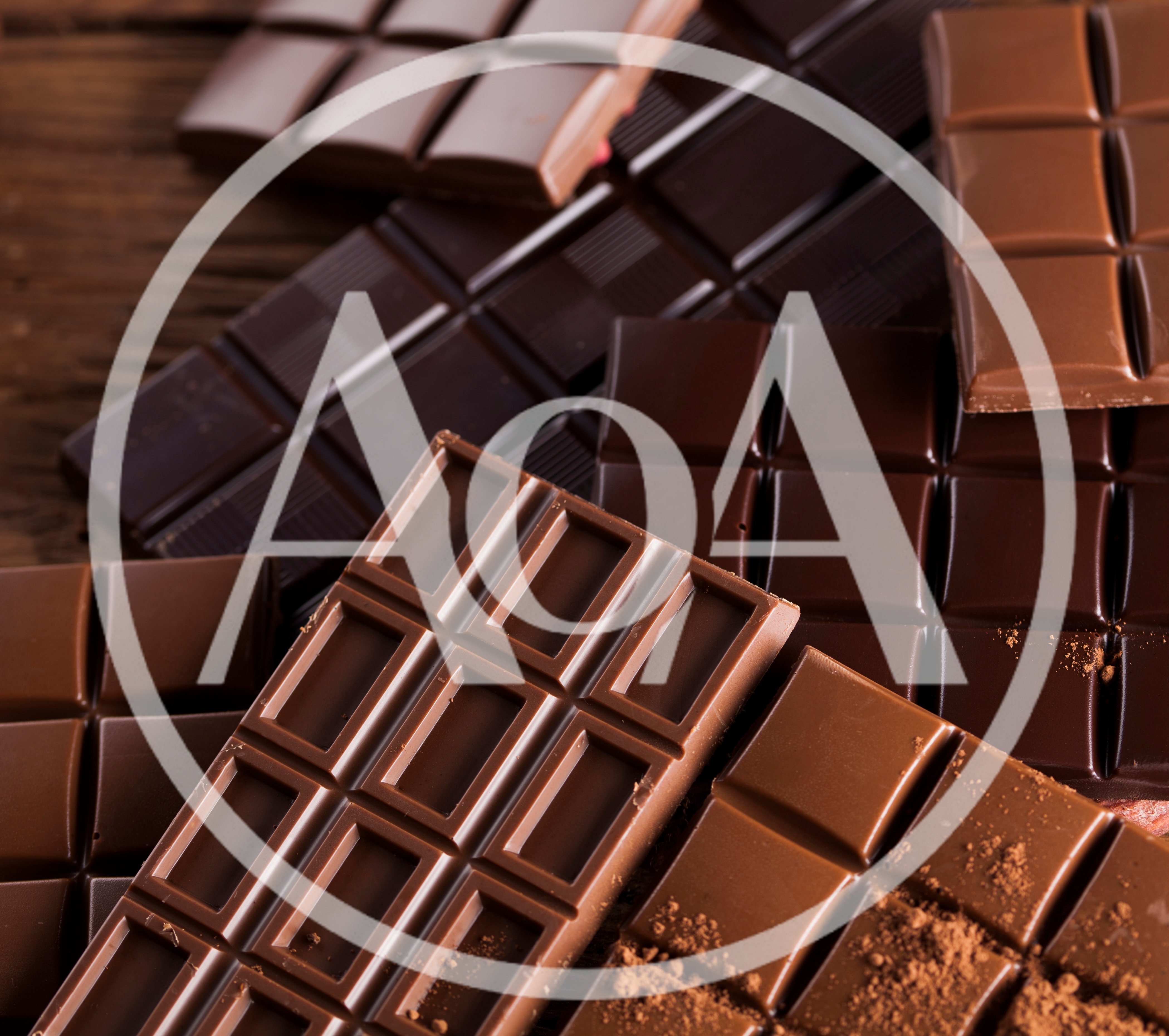 Assorted Chocolate Bars On A Rustic Wooden Surface