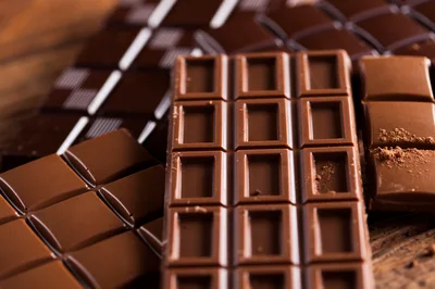 Assorted Milk and Dark Chocolate Bars on Wooden Surface