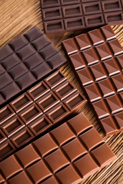 Assorted Chocolate Bars Arranged On A Wooden Surface