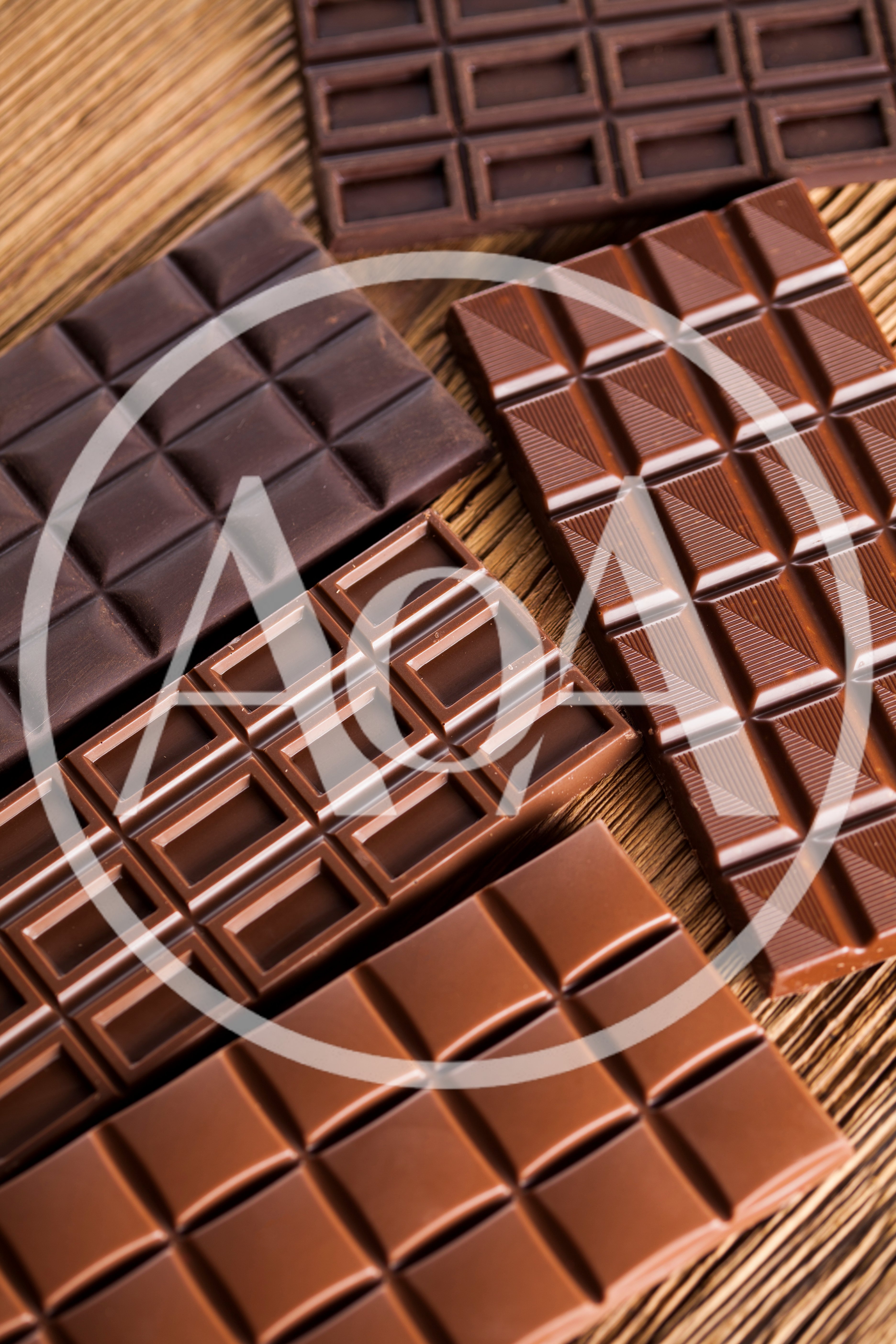 Assorted Chocolate Bars Arranged On A Wooden Surface