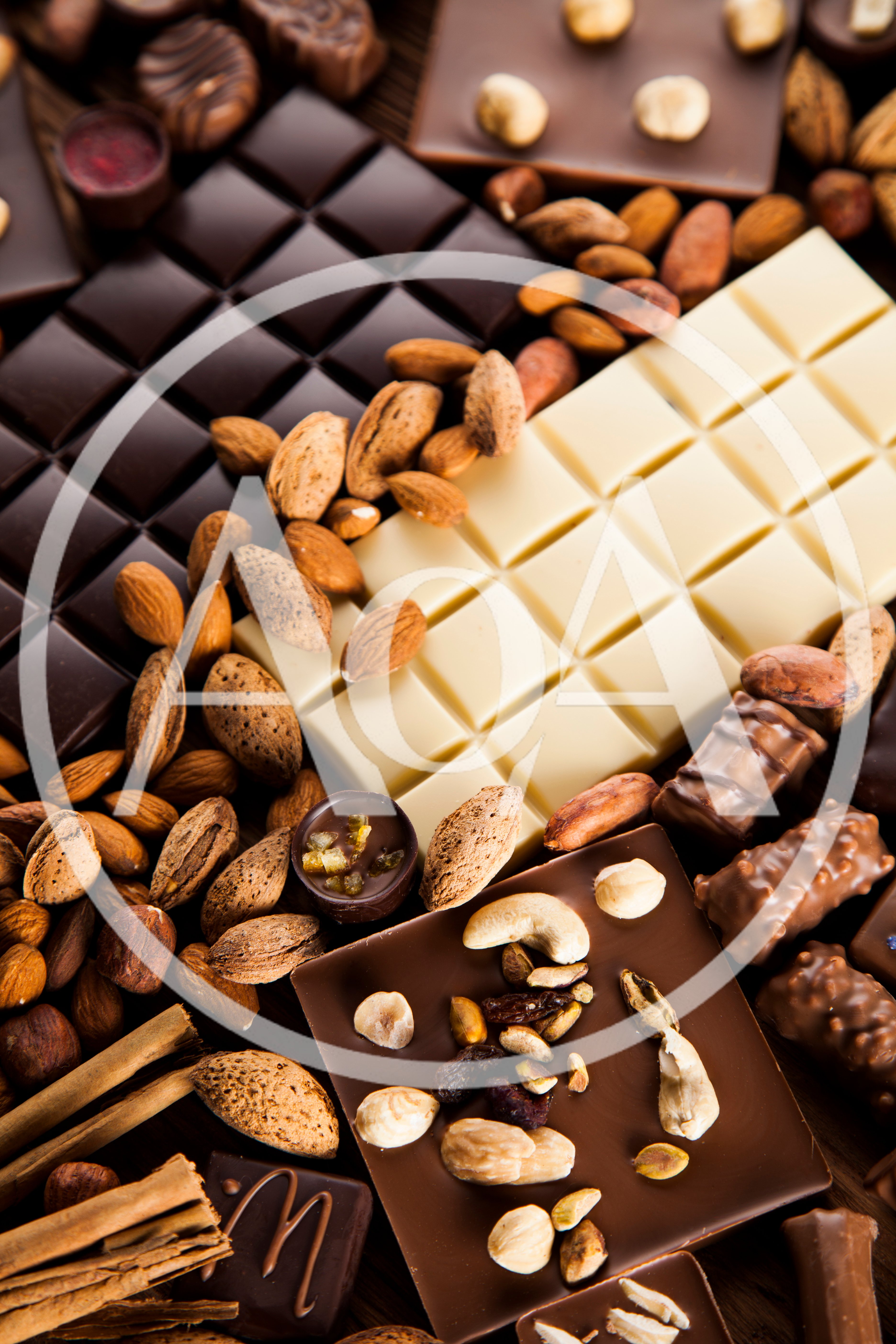 Assorted Chocolate Bars and Nuts on Wooden Background