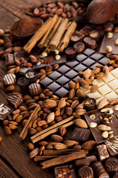 Assorted Chocolate Bars With Nuts And Cinnamon Sticks
