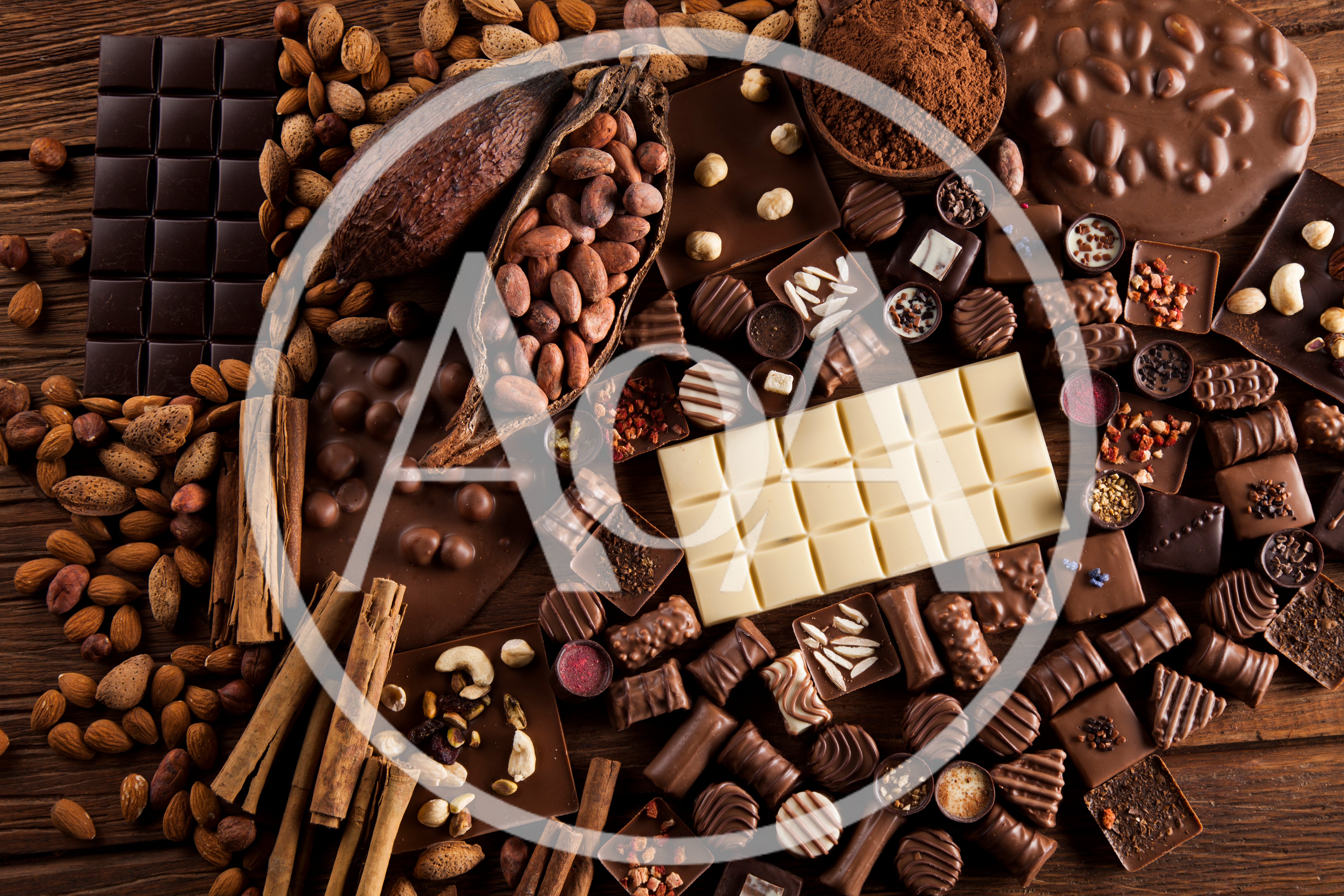 Assorted Chocolate Bars And Cocoa Ingredients On Wooden Table