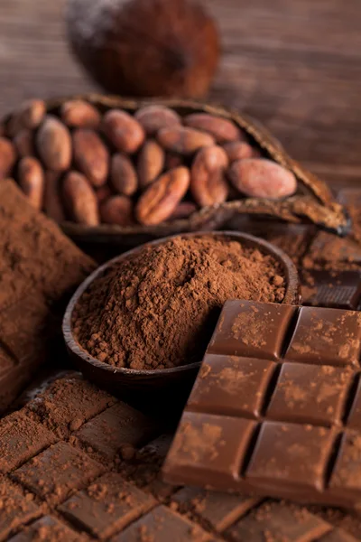 Cocoa Beans and Chocolate Bars on Wooden Table