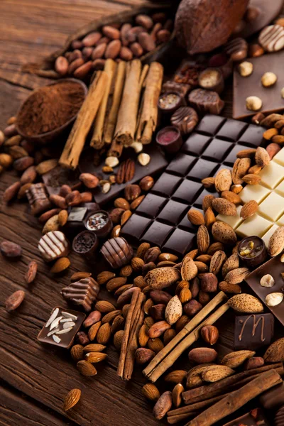 Assorted Chocolate Bars With Nuts And Cinnamon Sticks