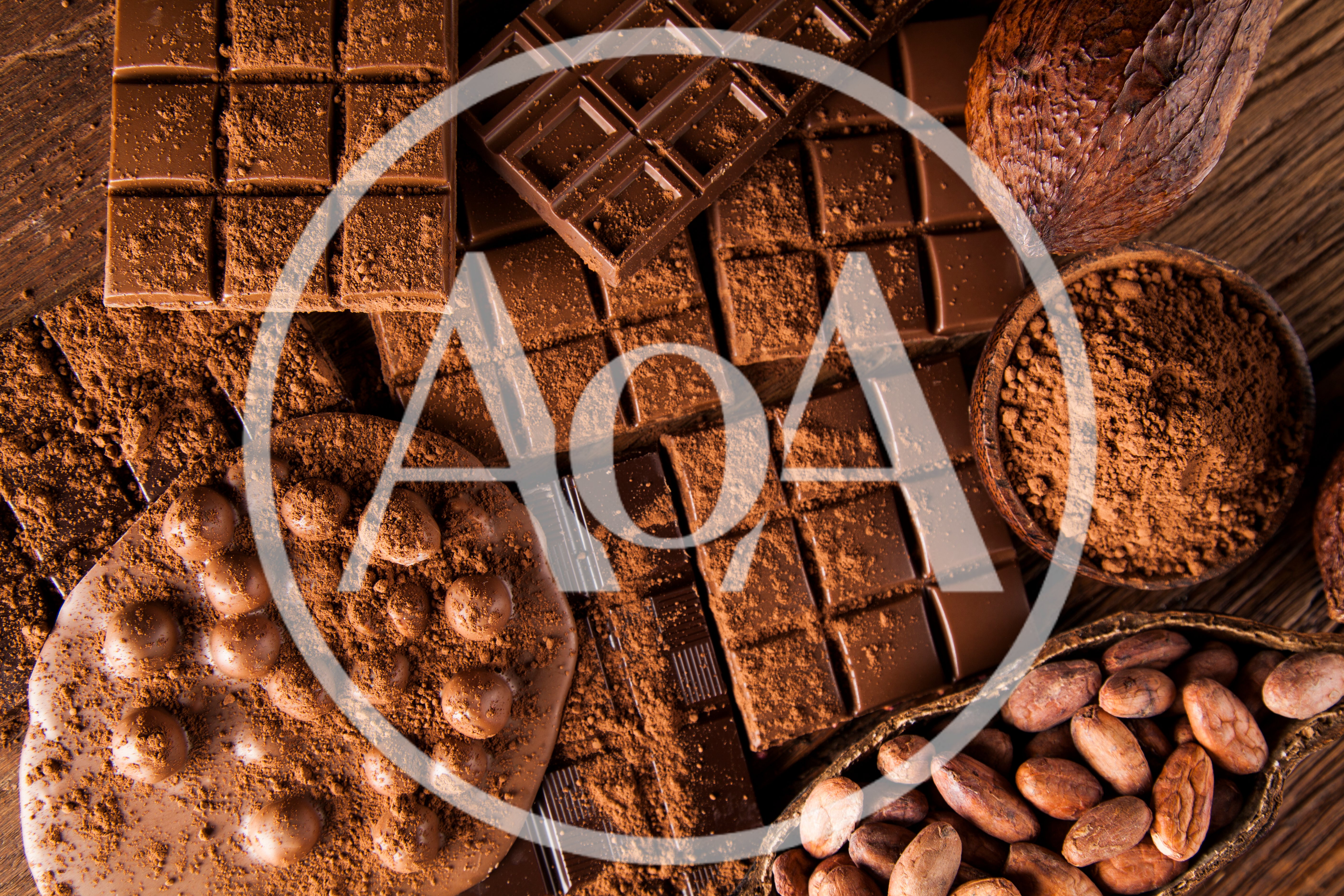 Assorted Chocolate Bars and Cocoa Beans on Wooden Table