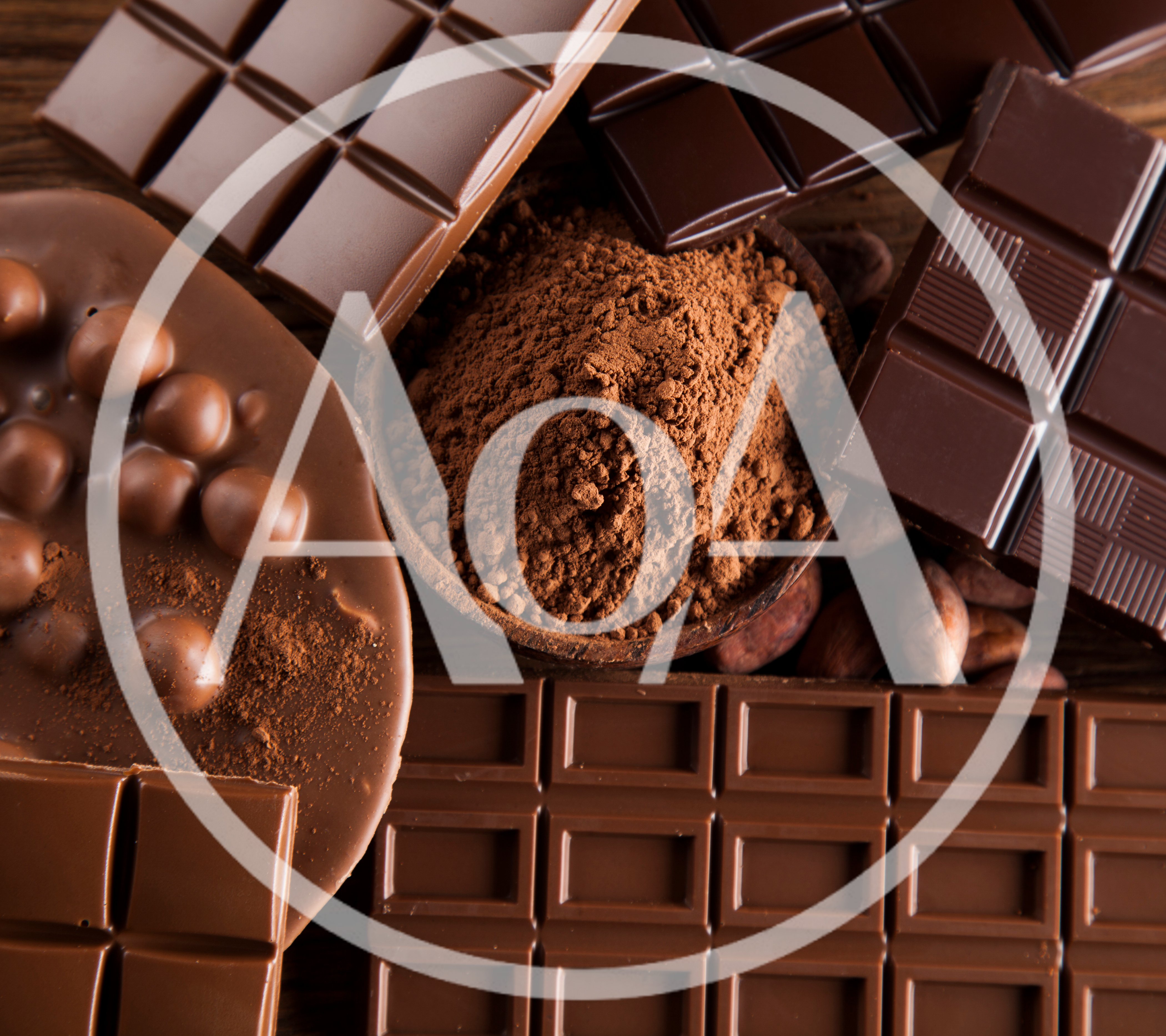 Assorted Chocolate Bars and Cocoa Powder on Wooden Table