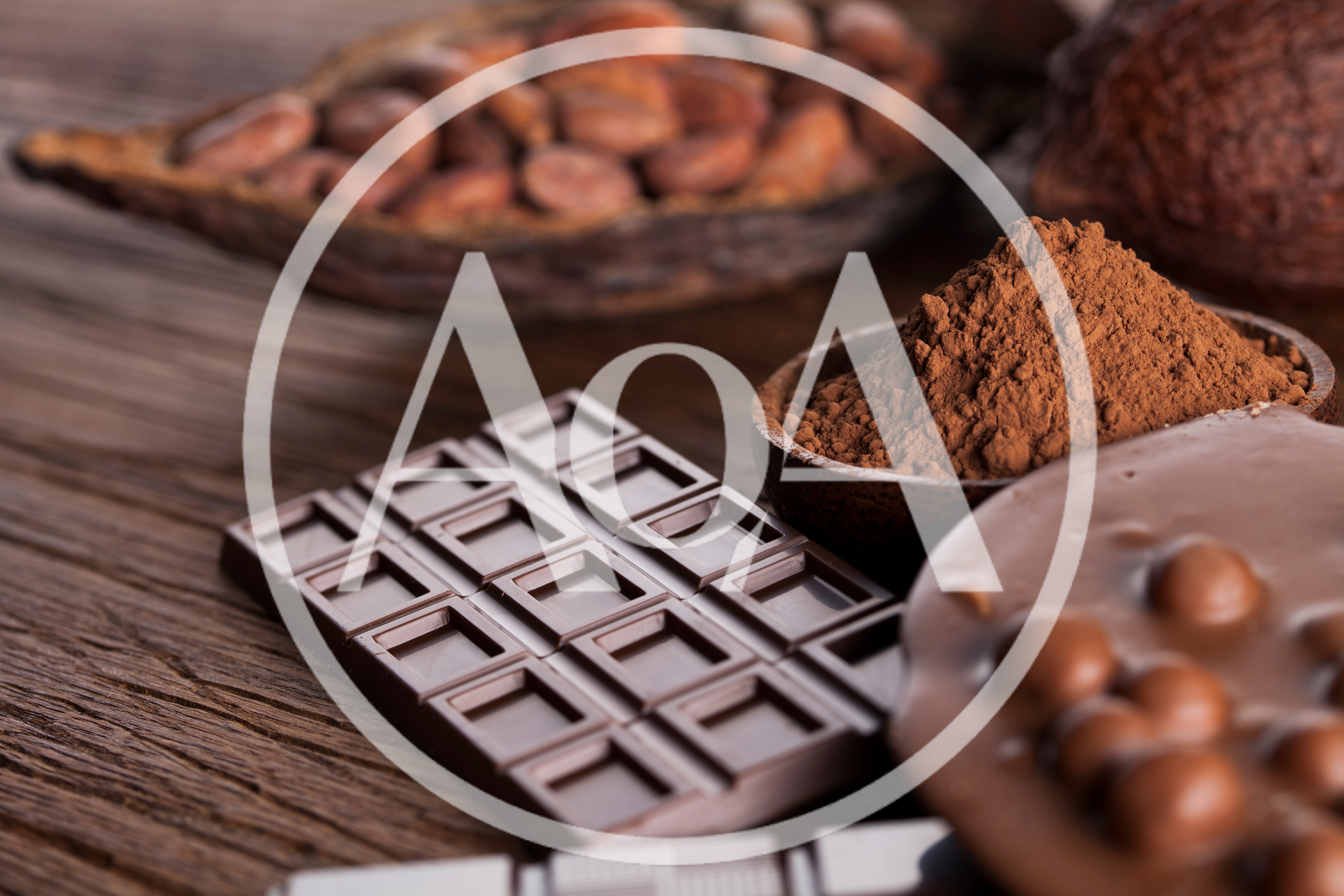 Dark Chocolate Bar And Cocoa Powder On Wooden Table