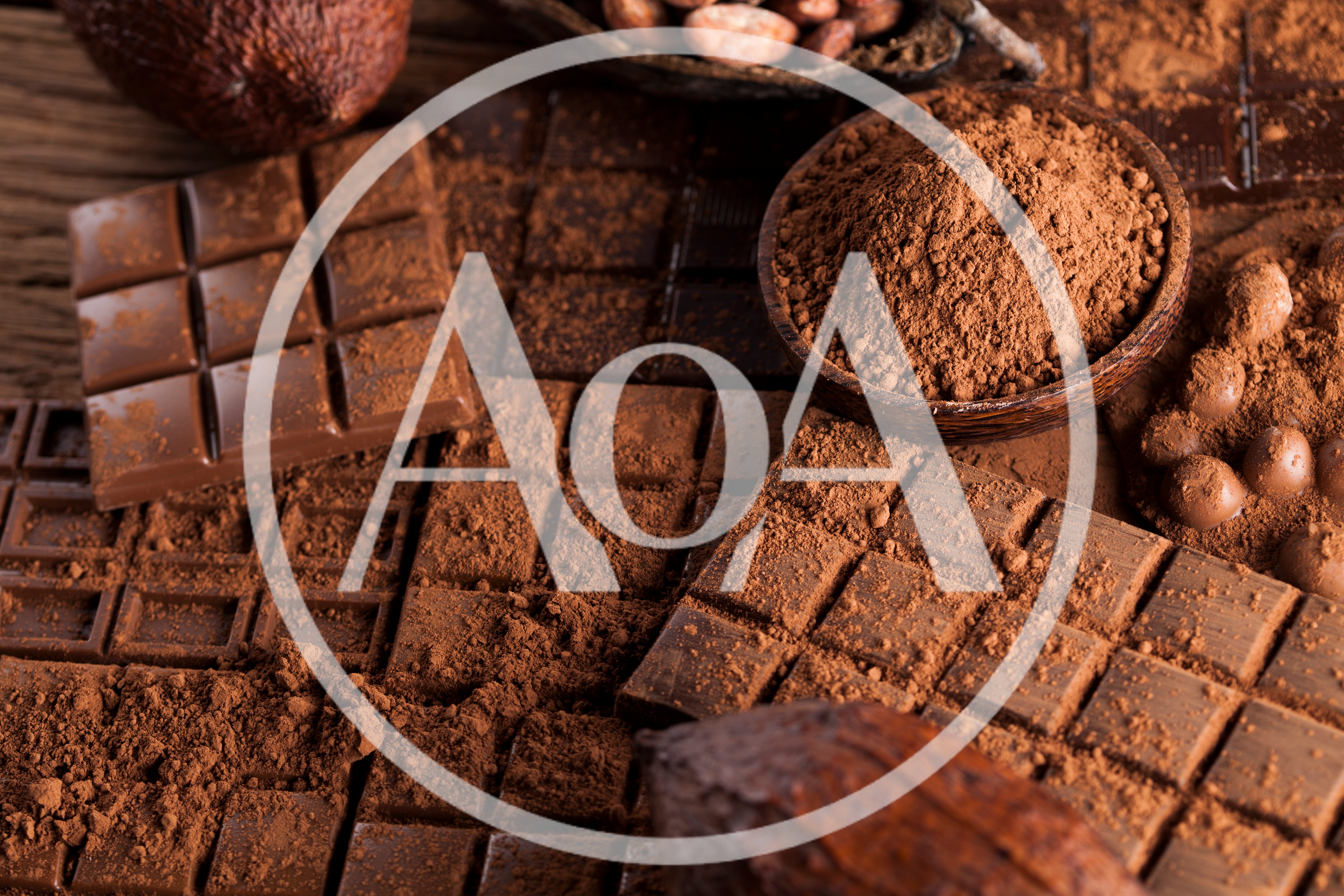 Assorted Chocolate Bars and Cocoa Powder on Wooden Table