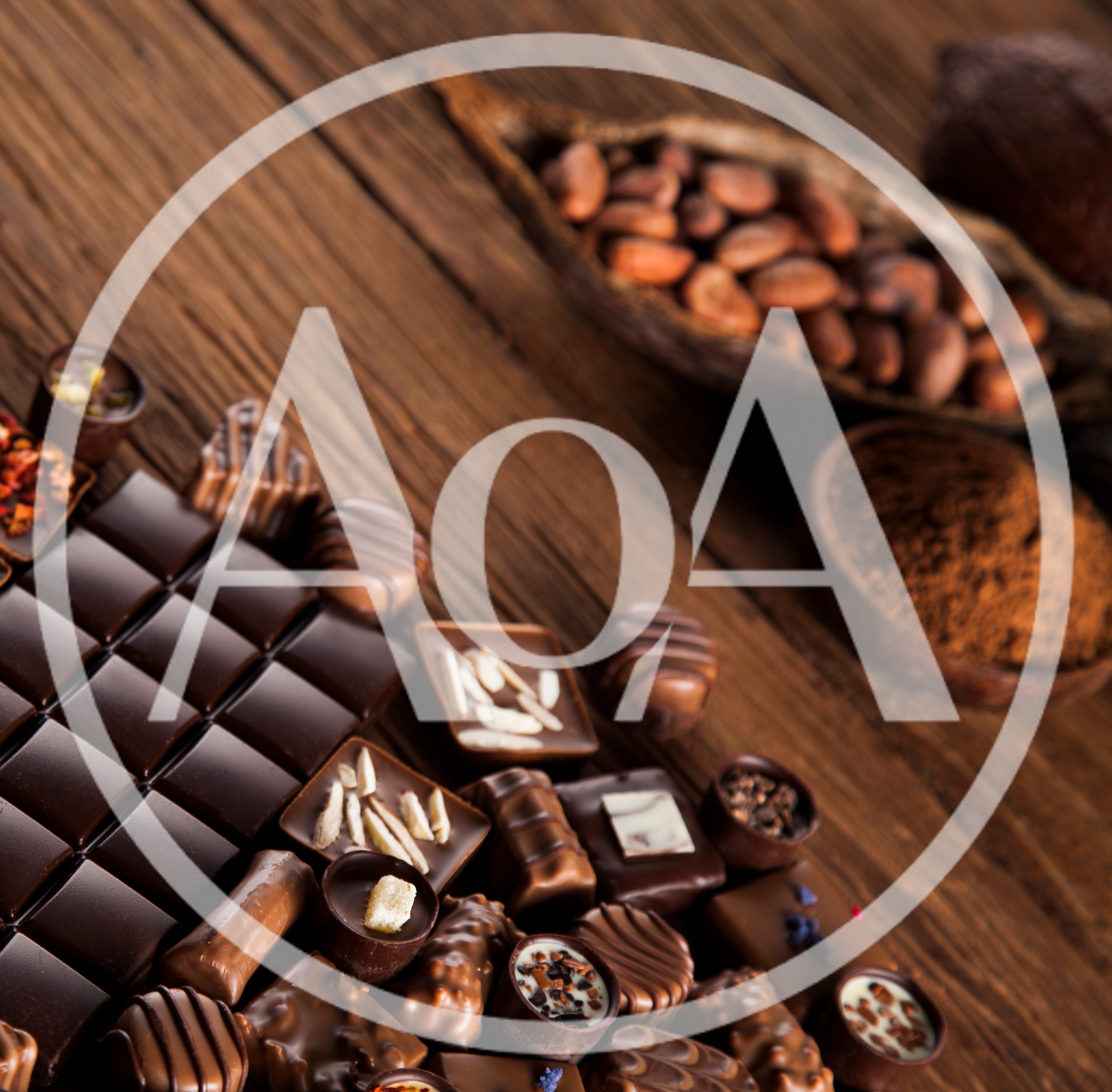 Assorted Gourmet Chocolates and Cocoa Beans on Wood