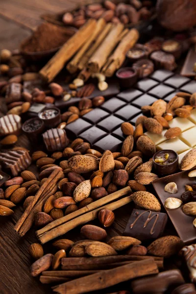 Assorted Chocolate Bars With Nuts And Cinnamon Sticks