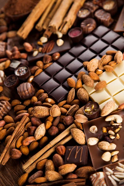 Assorted Chocolate Bars With Nuts And Cinnamon Sticks