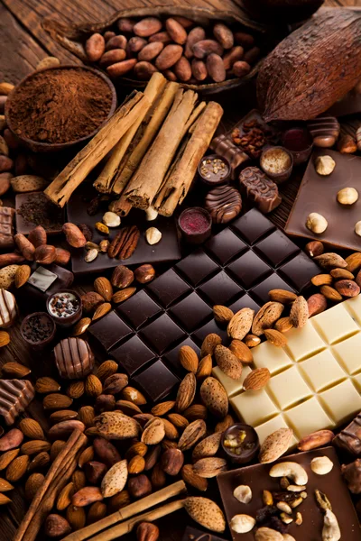 Assorted Chocolate Bars With Nuts And Cinnamon Sticks