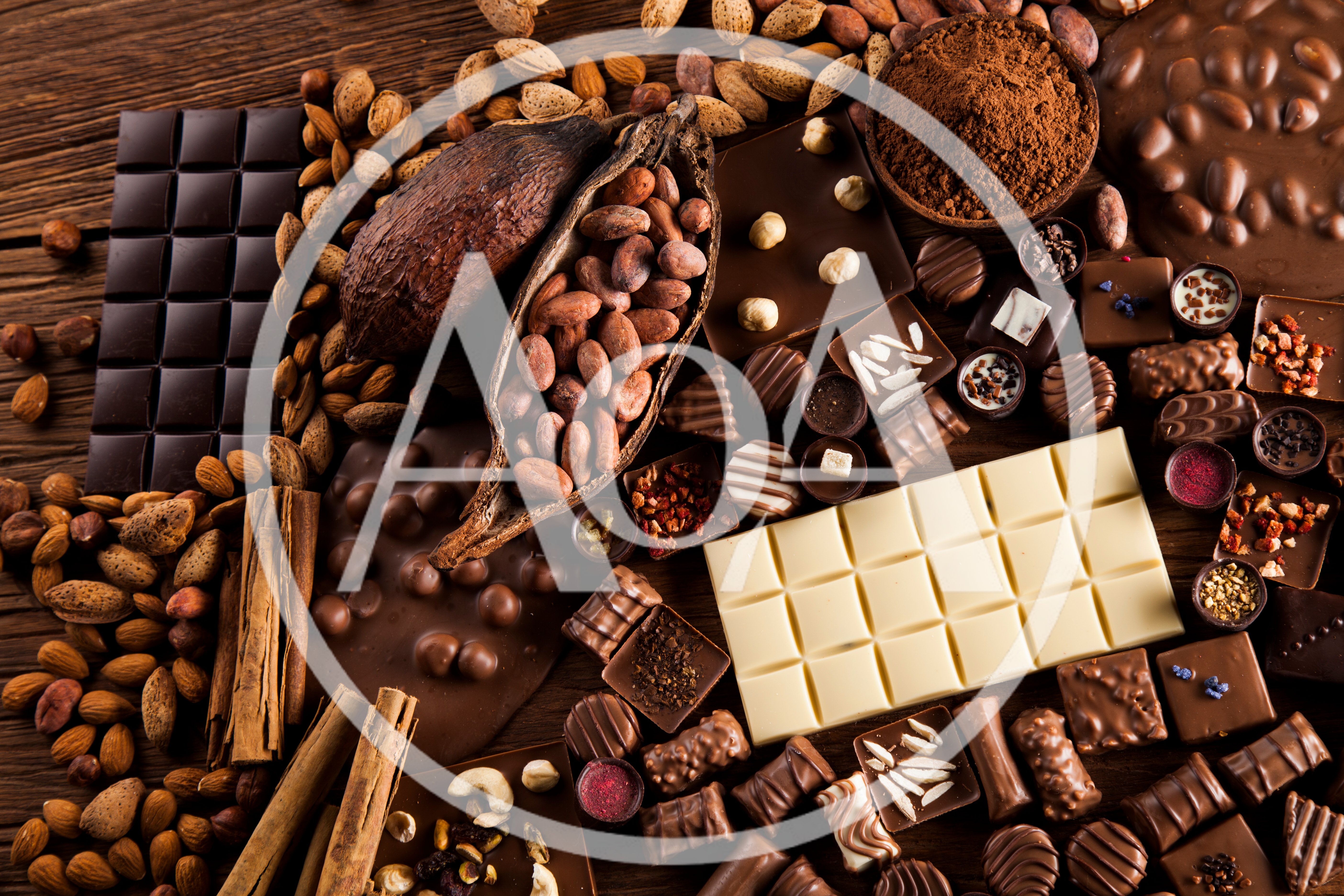 Assorted Chocolate Bars and Cocoa Beans on Wooden Table