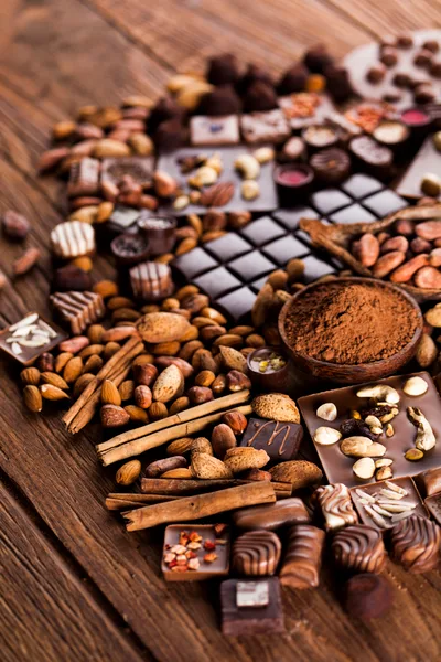 Assorted Chocolates and Nuts on Rustic Wooden Table
