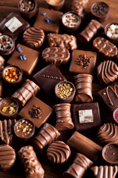 Assorted Gourmet Chocolate Truffles on Wooden Background