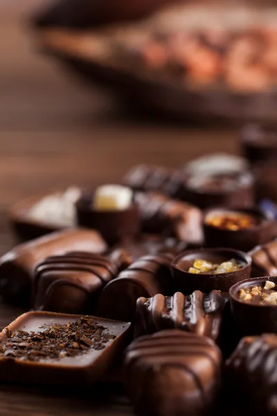 Assorted Gourmet Chocolate Pralines On Wooden Table