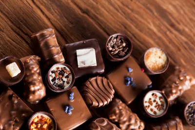Assorted Gourmet Chocolate Truffles on Wooden Background