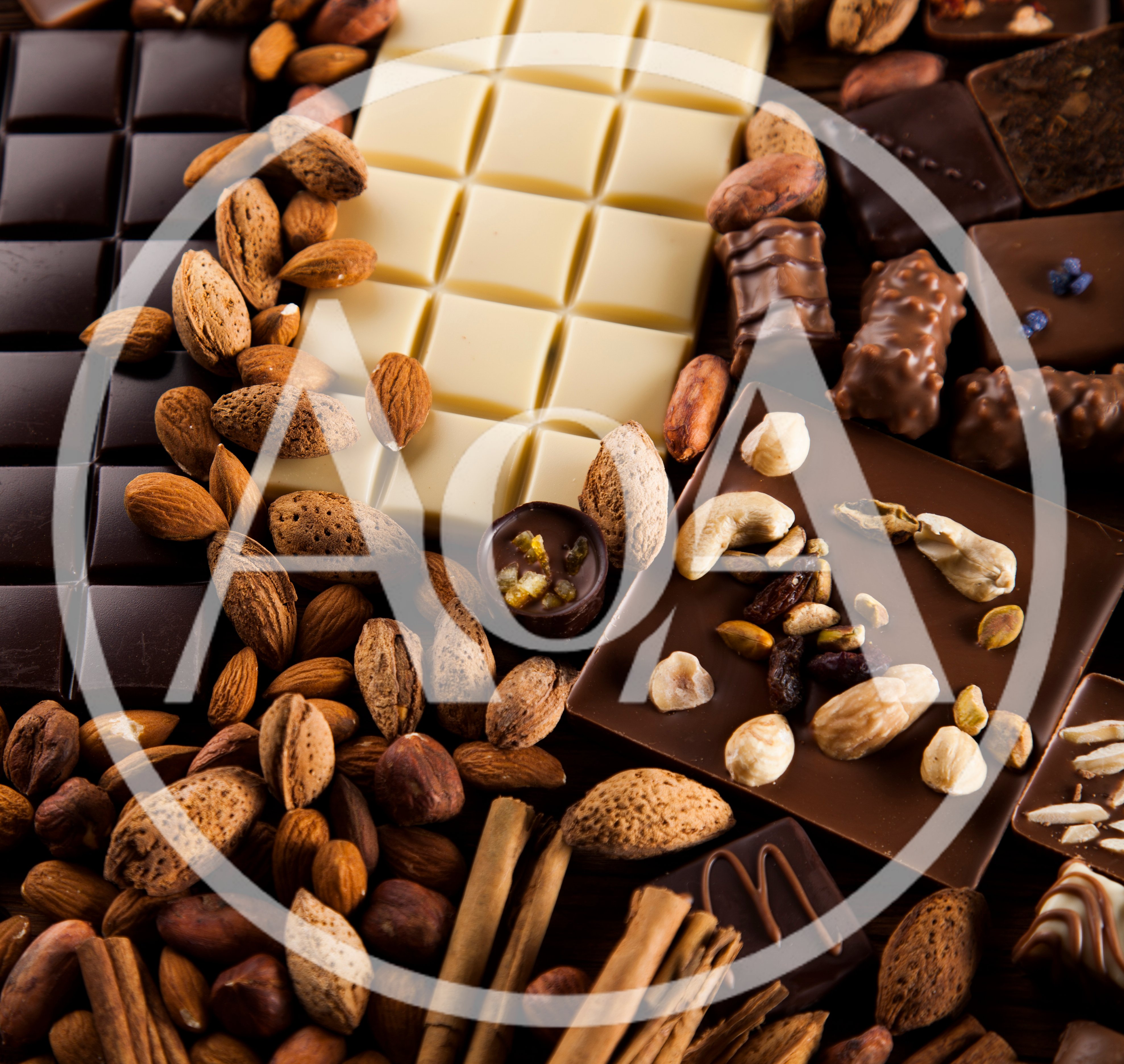 Assorted Chocolate Bars and Nuts on Wooden Table