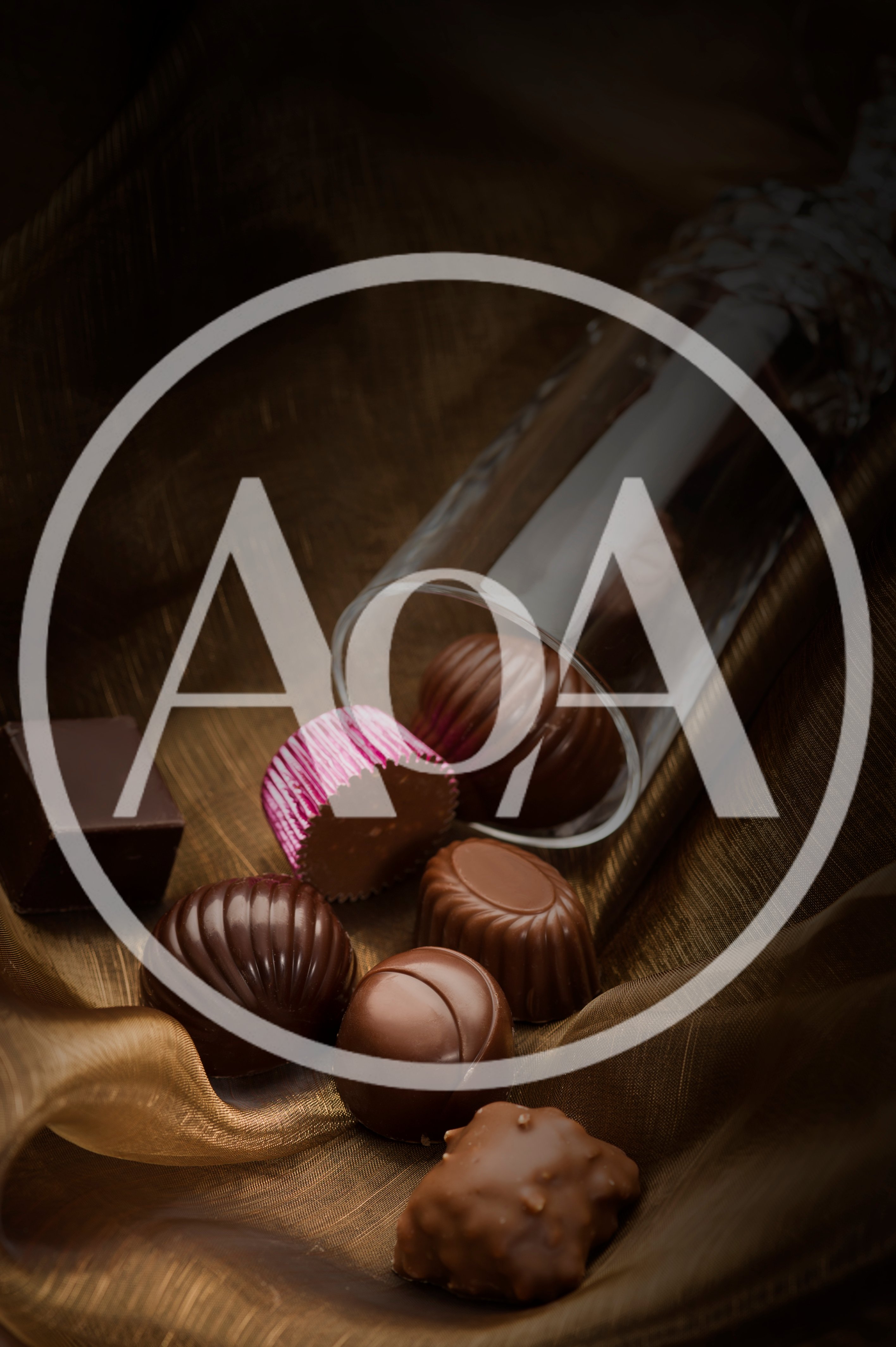 Assorted Gourmet Chocolates Spilled From A Glass