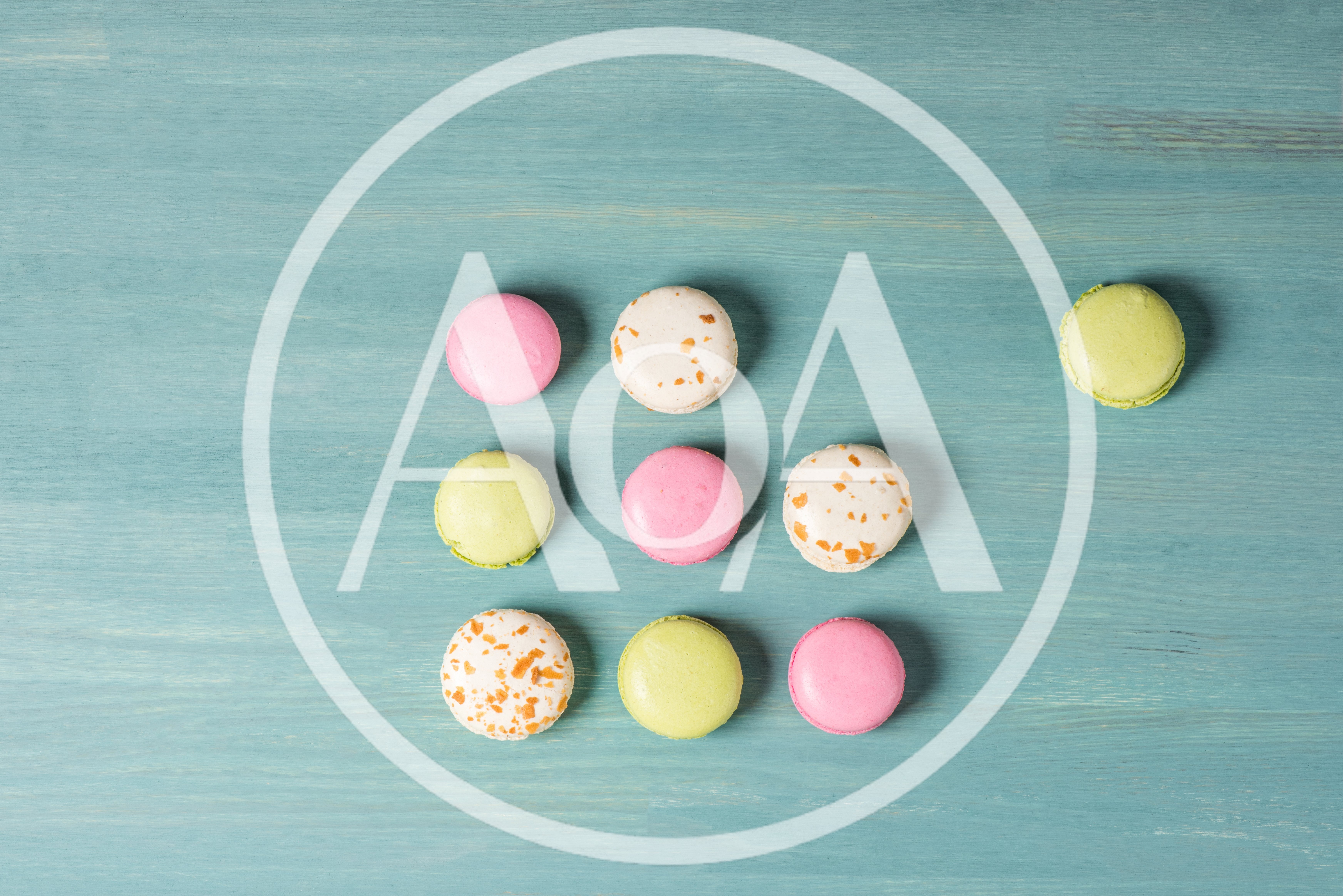 Colorful Macarons Arranged In A Grid On Blue Wood
