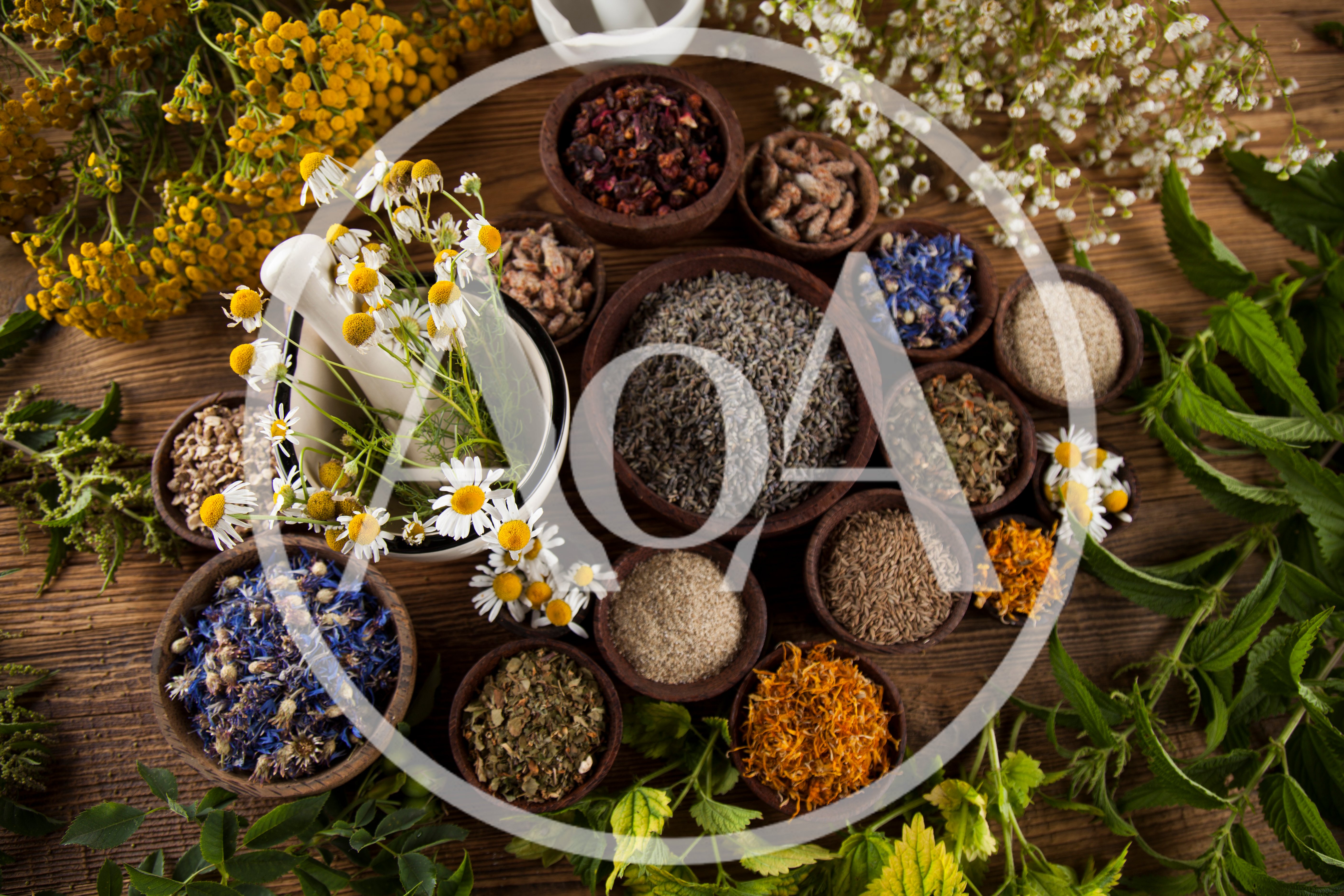 Assorted Dried Herbs And Flowers In Wooden Bowls
