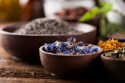 Dried Cornflower Petals In A Small Wooden Bowl