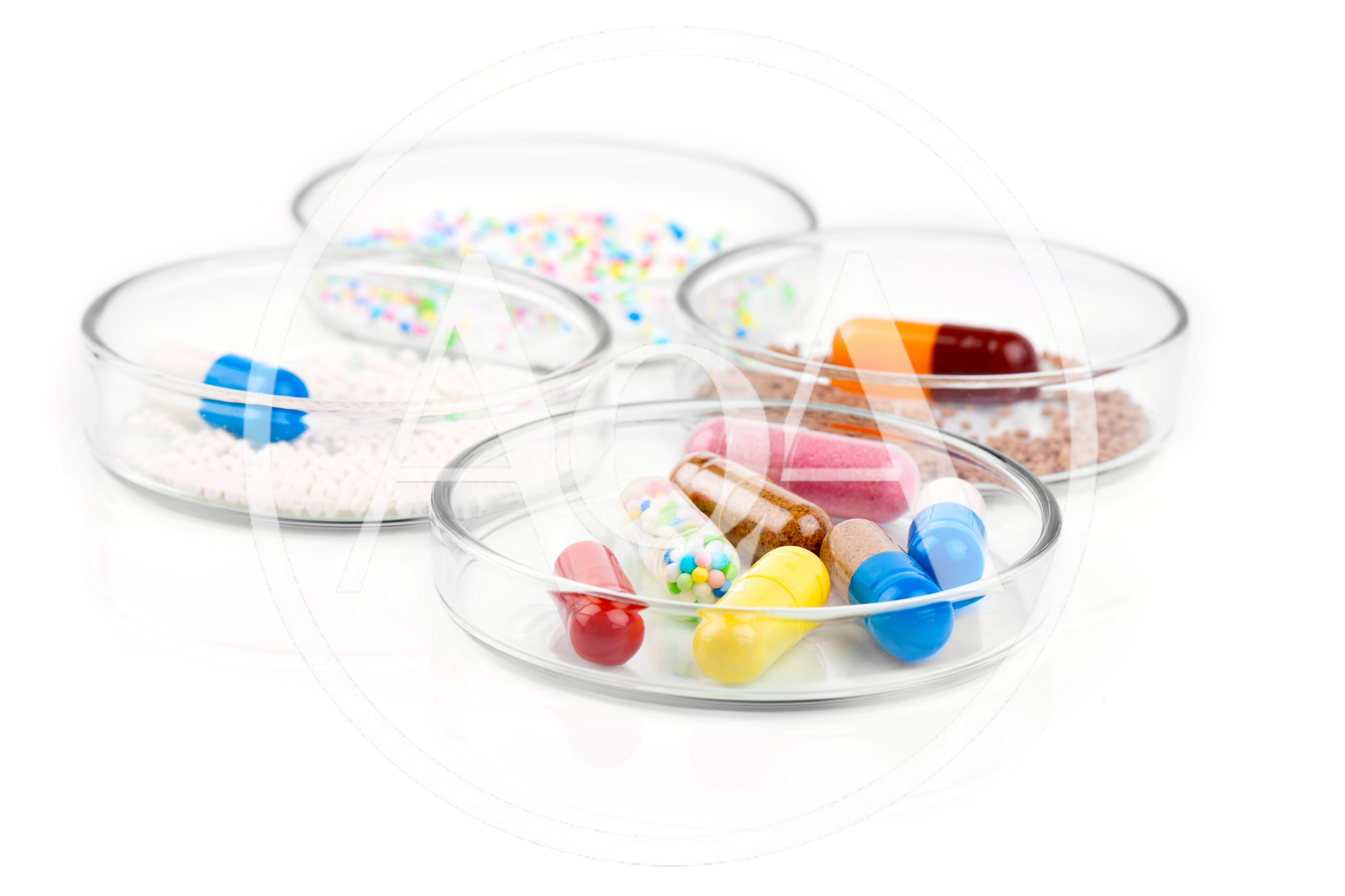 Assorted Pharmaceutical Capsules and Granules in Glass Petri Dishes