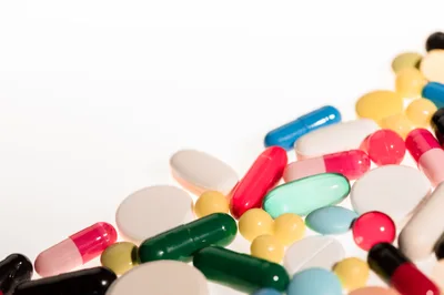 Assorted Pharmaceutical Pills and Capsules on White Background