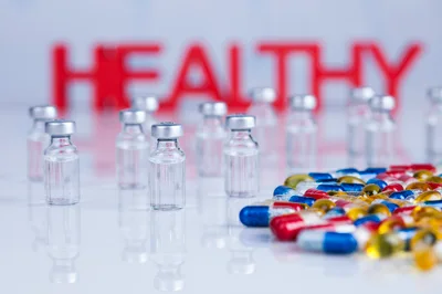 Medical Vials and Colorful Capsules with Healthy Text