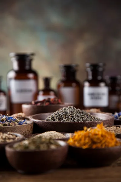Assorted Dried Herbs and Flowers in Wooden Bowls