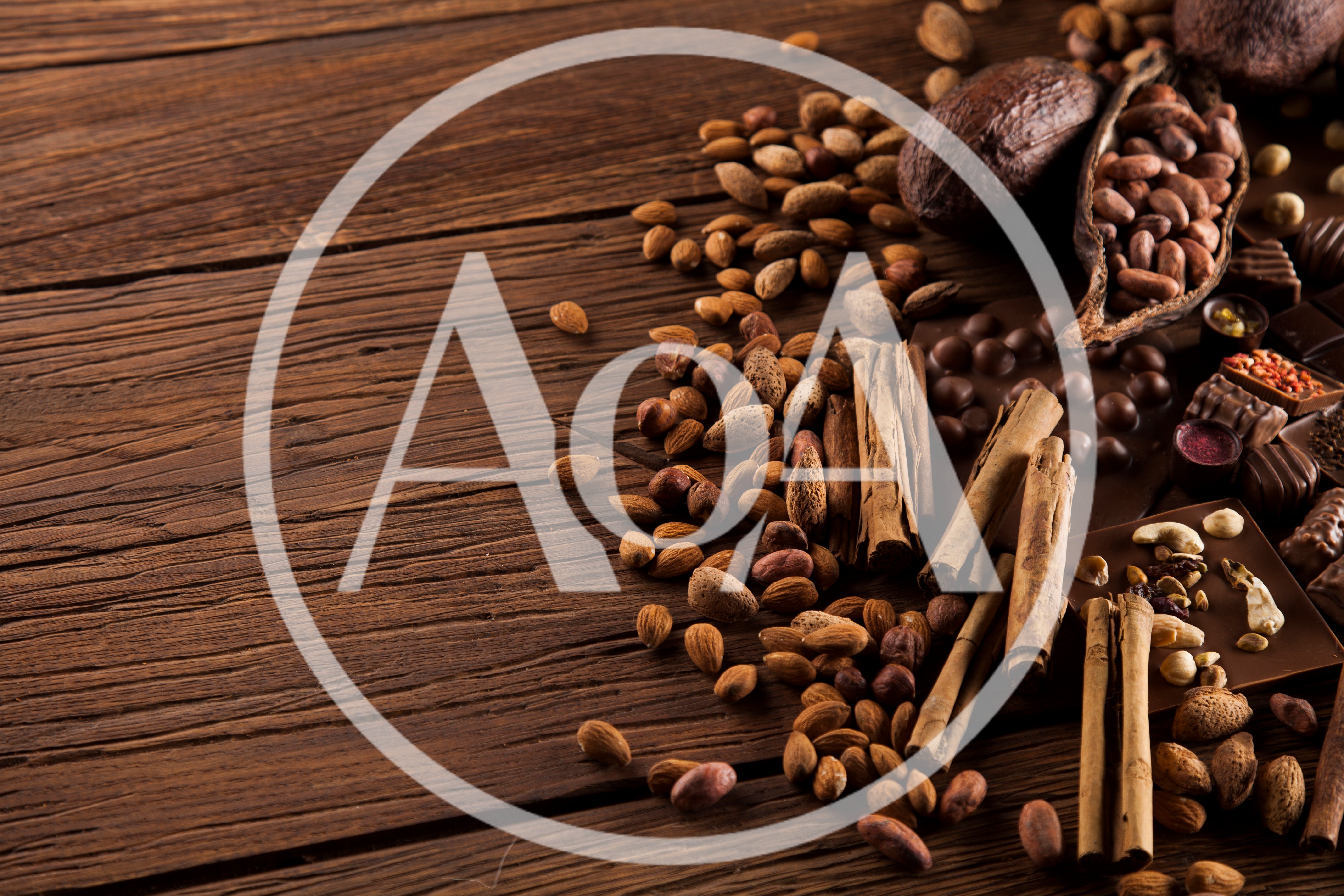 Assorted Cocoa Beans And Spices On Wooden Table