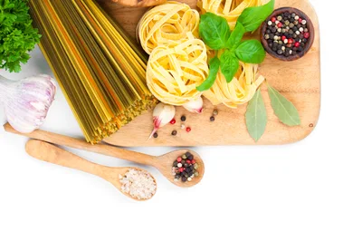 Assorted Pasta Ingredients On A Wooden Cutting Board