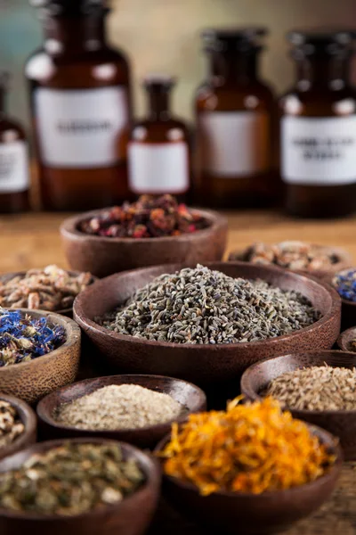 Assorted Dried Herbs And Spices In Wooden Bowls