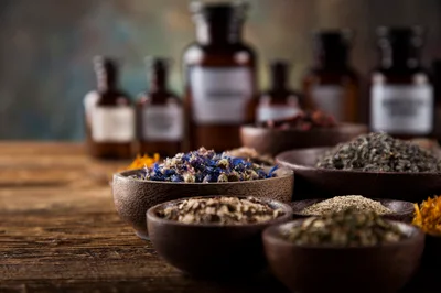 Assorted Dried Herbs and Medicinal Flowers in Wooden Bowls