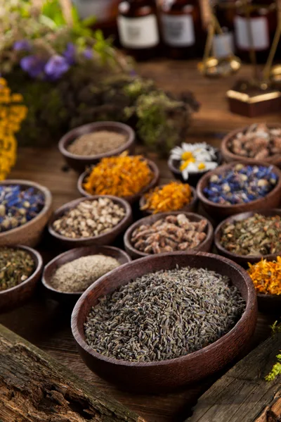 Assorted Dried Herbs and Flowers in Wooden Bowls