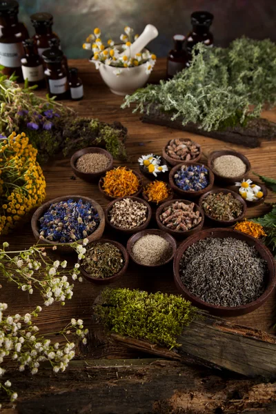Herbal Medicine Ingredients And Dried Flowers On Wooden Table